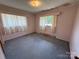Bedroom with two windows, pink walls, carpet flooring, and fair natural light at 1012 Burrage Ne Rd, Concord, NC 28025