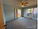 Bedroom with a sliding glass door leading to the backyard and a ceiling fan at 1012 Burrage Ne Rd, Concord, NC 28025