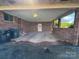 Spacious brick carport with a concrete floor, overhead lighting, and covered parking at 1012 Burrage Ne Rd, Concord, NC 28025