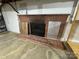 Basement brick fireplace with a black metal frame, rustic charm and potential for cozy evenings at 1012 Burrage Ne Rd, Concord, NC 28025