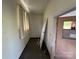 Small hallway room with peeling paint, a window, and an ajar door at 1012 Burrage Ne Rd, Concord, NC 28025
