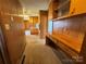 Galley kitchen featuring wood cabinets and countertops, a desk area, and a view to the living area at 1012 Burrage Ne Rd, Concord, NC 28025