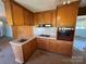 Well-organized kitchen with a peninsula, light countertops, and vintage oven at 1012 Burrage Ne Rd, Concord, NC 28025
