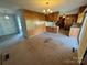 Combined living area and kitchen with wood paneled walls at 1012 Burrage Ne Rd, Concord, NC 28025