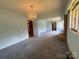 Spacious living room featuring a classic chandelier and view of the fireplace at 1012 Burrage Ne Rd, Concord, NC 28025