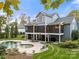 Exterior view of home with pool, screened-in porch and lush backyard at 1068 Grant Dr, Denver, NC 28037