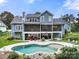 Stunning backyard with a pool, patio, and beautifully landscaped yard at 1068 Grant Dr, Denver, NC 28037