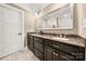 Double vanity bathroom featuring dark cabinets, granite countertop, and large mirror at 1068 Grant Dr, Denver, NC 28037