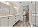 Bathroom featuring a walk-in shower with tile surround, double sinks and stylish fixtures at 1068 Grant Dr, Denver, NC 28037