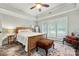 Bedroom with natural light, tray ceiling, ceiling fan and dark tile floor and neutral walls at 1068 Grant Dr, Denver, NC 28037