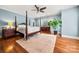 Spacious bedroom featuring a four-poster bed, hardwood floors, and serene blue walls at 1068 Grant Dr, Denver, NC 28037