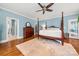 Serene bedroom featuring a four-poster bed, hardwood floors, and natural light at 1068 Grant Dr, Denver, NC 28037