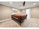 Neutral bedroom with carpet, metal bed frame and ceiling fan, leading to outdoor porch at 1068 Grant Dr, Denver, NC 28037