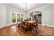 Bright dining room with a rustic wood table and bench, chandelier, and access to an outdoor porch at 1068 Grant Dr, Denver, NC 28037