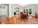 Elegant dining room featuring hardwood floors, chandelier, and French doors leading to a covered outdoor area at 1068 Grant Dr, Denver, NC 28037