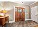 Inviting entryway featuring a wooden front door, tile floors, and elegant accents at 1068 Grant Dr, Denver, NC 28037