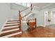Elegant entryway with hardwood floors, staircase, and decorative table at 1068 Grant Dr, Denver, NC 28037