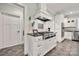 Gourmet kitchen with custom white cabinetry, stainless steel appliances, and stylish tile backsplash at 1068 Grant Dr, Denver, NC 28037