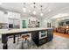 Island kitchen with modern appliances, pendant lighting, breakfast bar, and access to the dining area at 1068 Grant Dr, Denver, NC 28037