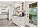 Well-lit kitchen with stainless steel refrigerator, custom cabinetry, and breakfast bar that leads to a covered outdoor area at 1068 Grant Dr, Denver, NC 28037