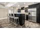 Finished basement kitchenette with stainless steel appliances, dark cabinets, and modern lighting at 1068 Grant Dr, Denver, NC 28037