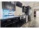 Finished basement kitchenette with stainless steel appliances, dark cabinets, and modern lighting at 1068 Grant Dr, Denver, NC 28037