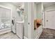 Well-equipped laundry room featuring modern washer and dryer units and built-in shelving at 1068 Grant Dr, Denver, NC 28037
