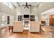 Open-concept living room featuring a fireplace, hardwood floors, and plenty of seating at 1068 Grant Dr, Denver, NC 28037