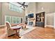Elegant living room with stone fireplace, built-in bookshelves, and hardwood floors at 1068 Grant Dr, Denver, NC 28037