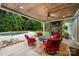 Covered outdoor patio with stone fireplace, ceiling fan, and seating overlooking the pool at 1068 Grant Dr, Denver, NC 28037