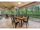 Inviting screened porch with wooded view, tile floor and wood plank ceiling with ceiling fan at 1068 Grant Dr, Denver, NC 28037