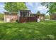 Brick home featuring a screen porch, back deck, and spacious yard at 111 Peoria Ln, Kings Mountain, NC 28086
