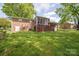 Brick home featuring a screen porch, back deck, and spacious yard at 111 Peoria Ln, Kings Mountain, NC 28086