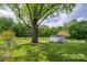 Landscaped backyard with mature trees, storage shed and fenced in yard at 111 Peoria Ln, Kings Mountain, NC 28086