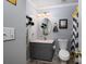 Cozy bathroom featuring a single sink vanity, oval mirror, and shower with a stylish black and white curtain at 111 Peoria Ln, Kings Mountain, NC 28086