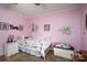 Adorable pink bedroom featuring a white bed frame, cheerful décor, and a ceiling fan at 111 Peoria Ln, Kings Mountain, NC 28086