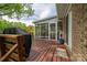 Outdoor deck area featuring a covered grill, seating and partial view into the screened-in porch at 111 Peoria Ln, Kings Mountain, NC 28086