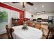 Charming dining area featuring a round table, wooden chairs, and a bright red accent wall adjacent to the kitchen at 111 Peoria Ln, Kings Mountain, NC 28086