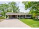 Charming single story brick home with a covered front porch, carport, and well-manicured lawn at 111 Peoria Ln, Kings Mountain, NC 28086