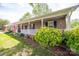 Charming brick home featuring a spacious porch, neat landscaping, and an American flag at 111 Peoria Ln, Kings Mountain, NC 28086