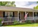 Inviting front porch with cozy seating, brick accents and attractive landscaping at 111 Peoria Ln, Kings Mountain, NC 28086