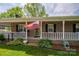 Charming brick home featuring a welcoming front porch and manicured landscaping at 111 Peoria Ln, Kings Mountain, NC 28086
