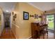 Bright hallway featuring hardwood floors, decorative wall art, and a vintage piano near the home's entrance at 111 Peoria Ln, Kings Mountain, NC 28086