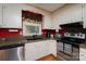 The kitchen showcases granite countertops, stainless steel appliances and bright red accent wall at 111 Peoria Ln, Kings Mountain, NC 28086