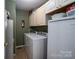 Functional laundry room with a washer, dryer, and ample storage space in the white overhead cabinets at 111 Peoria Ln, Kings Mountain, NC 28086