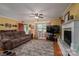 Inviting living room with a cozy brown sofa, a decorative fireplace, and a large television for entertainment at 111 Peoria Ln, Kings Mountain, NC 28086
