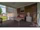 Comfortable screened porch with a wicker sofa and chair, offering a tranquil retreat for outdoor relaxation at 111 Peoria Ln, Kings Mountain, NC 28086