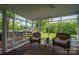 Inviting screened porch with wicker chairs and a view of the landscaped backyard at 111 Peoria Ln, Kings Mountain, NC 28086