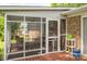 Enclosed screened porch with outdoor seating, offering a relaxing space with views of the surrounding greenery at 111 Peoria Ln, Kings Mountain, NC 28086