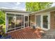 Well-maintained screened-in porch attached to a brick house, with a wooden deck at 111 Peoria Ln, Kings Mountain, NC 28086